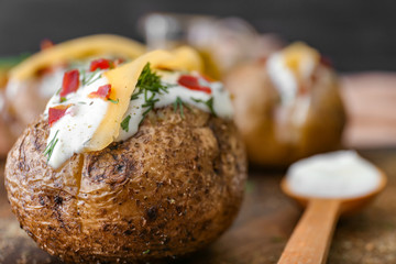 Tasty baked potato with sour cream, closeup