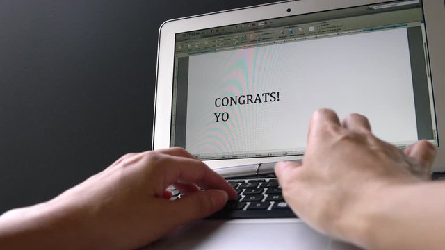 Woman typing the words, Congrats you got the job, on the computer screen. Letter of congratulatory on new job or promotion