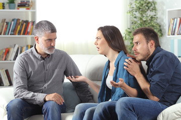 Angry father talking with daughter about scared boyfriend