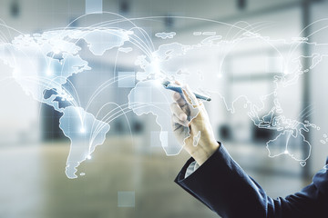 Man hand with pen working with abstract graphic digital world map with connections on blurred...