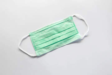 Green medical mask on a white background