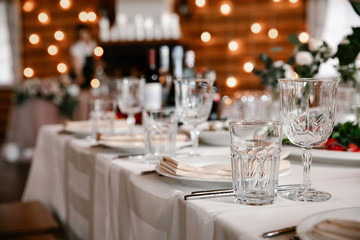 beautifully served table in a restaurant. Transparent Glass and glass in the foreground