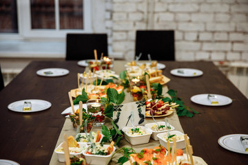 Banquet hall in the restaurant. Concept: Serving. Celebration. Anniversary. Wedding. Numbered table. A variety of salads and snacks