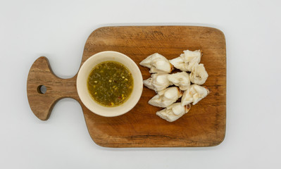 Jumbo lump of Fresh crab meat aside Seafood sauce with green chilli on wooden cutting board...