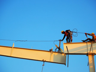 Man Working on the Working at height on construction site with blue sky