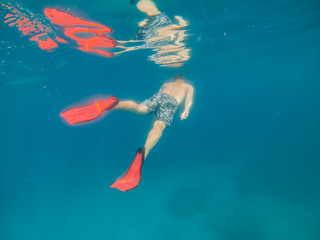 man in underwater in flippers looking at sea bottom © phpetrunina14