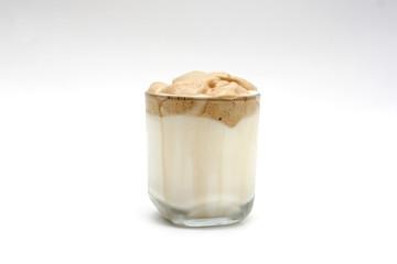 A glass of Dalgona coffee Korea favorite and good cool drink, Isolated white background