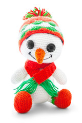 Handmade crochet snowman doll isolated on white background with shadow reflection. Playful crochet snow-man toy with orange scarf, sitting on white underlay. Knitted snowman plaything. Christmas theme