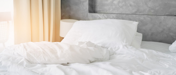 wrinkle white messy blanket on bed in bedroom in morning, panorama