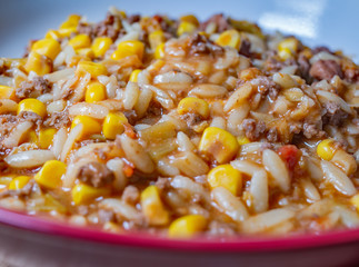  Close up and selective focus of minced beef, sweetcorn and orzo dinner in a serving dish