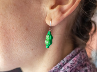 Close up and selective focus on novelty earrings on an unidentifiable lady