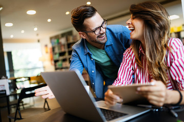Group of college students studying in the school library.