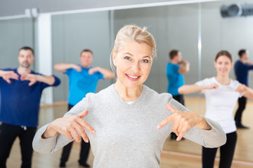 Fototapeta premium Middle-aged woman exercising at dance class