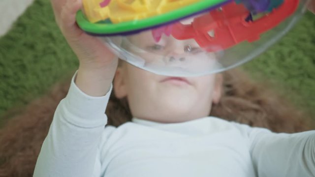 Little girl play with three-dimensional toy puzzle