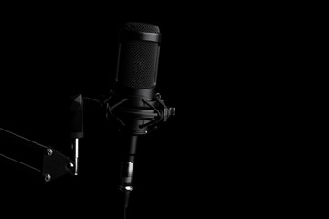 Studio condenser microphone, on black background.