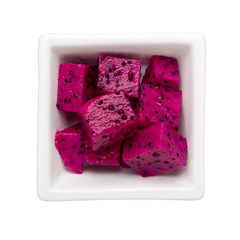 Pieces of red dragon fruit in a square bowl isolated on white background; ; 

