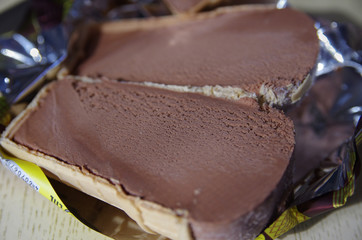 Chocolate ice cream in a waffle Cup cut into two parts