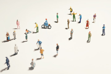 Top view of people (miniature toys) with long shadows keep distance away in public during sunrise or sunset.Social distancing / COVID-19 coronavirus outbreak spreading concept. - obrazy, fototapety, plakaty