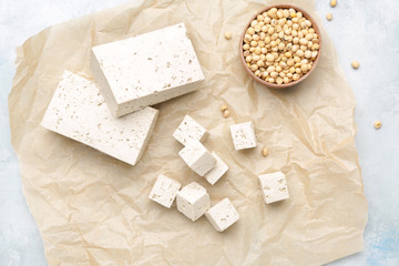 Parchment with tasty tofu cheese on table
