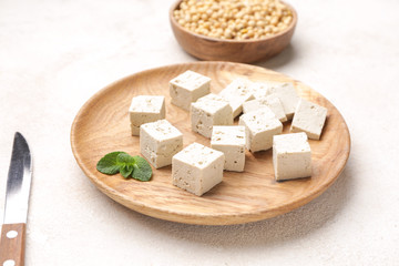 Plate with tasty tofu cheese on white background