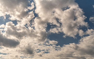 the blue sky with grey and white clouds