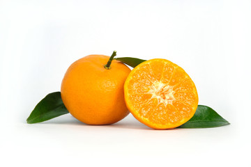 Half sliced and raw of Citrus sinensis ( called jeruk baby santang ) with leaves – local fresh fruit from Indonesia. Isolated fruit on a wooden basket / bowl