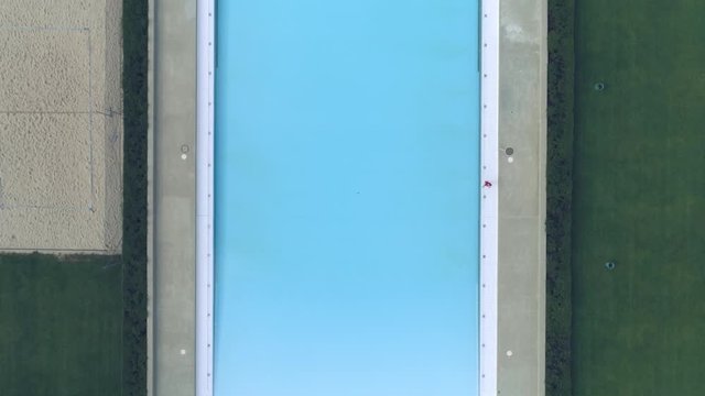 Drone shot of an empty outdoor swimming pool
