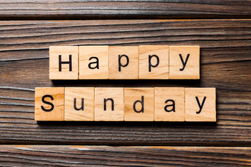 Happy sunday word written on wood block. Happy sunday text on wooden table for your desing, concept