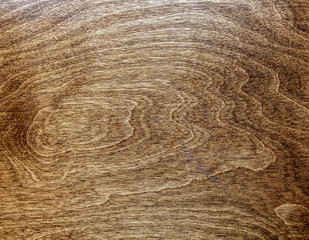 dark lacquered veined wood surface top view, brown background texture