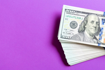Top view of bundle of 100 dollar bill on colorful backgound. Business concept with copy space
