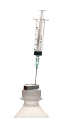 Empty syringe for injection with a neck of a plastic bottle on a white background.
