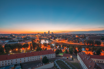 Vilnius, Lithuania, Europe. Sunset Cityscape. Modern Office Buildings Skyscrapers In Business District New City Center Shnipishkes In Night Illuminations
