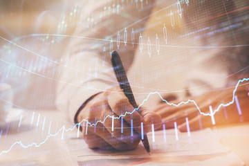 Financial trading graph multi exposure with man desktop background.