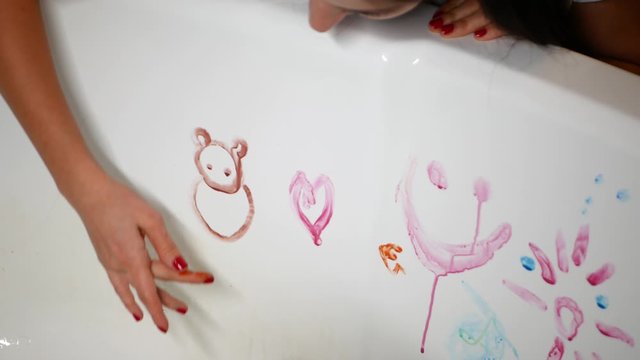 mom and child draw in the bathroom