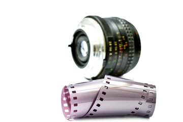 camera film in front of vintage manual focus lens