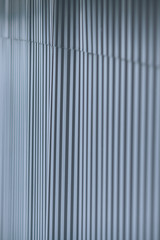 Fototapeta premium Abstract background, a fence of metal sheets. Metal rolling, metal profile, blurred texture with copy space.