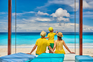 Family with three year old boy on beach. Seychelles, Mahe.