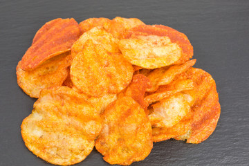 heap of potato crisps snack with paprika and sour cream flavor