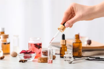 Foto op Plexiglas Woman preparing perfume on table © Pixel-Shot