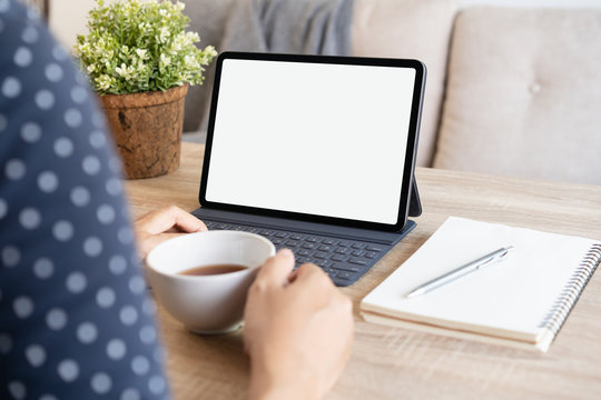 Mockup. Blank digital tablet in the hands of Asian women, Tablet computer white screen. Businesswoman work from home