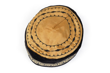 Headdress known as tubeteika on a white background, top view