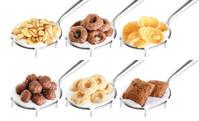 Spoon with corn pads, rings, balls, oat granola, cornflakes and yogurt isolated on white background.