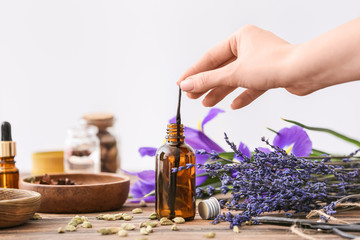 Woman preparing perfume on table