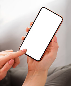 Person holding smartphone with blank screen in hands