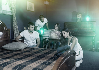 Young adults in escape room with antique furnitures