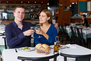 Glad couple spending time in restaurant