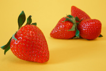 Fresh strawberries on a yellow background