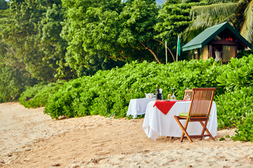 Table set up for romantic dinner on beach at Seychelles