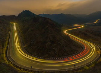 highway light trails of vehicles during rush hour and sunset