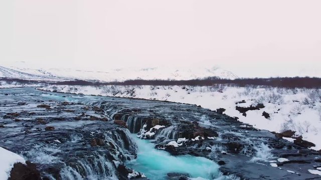 Landscape View Of Bruarfoss Waterfalls Surrounded By White Thick Snow In Iceland During Wintertime.-aerial drone shot